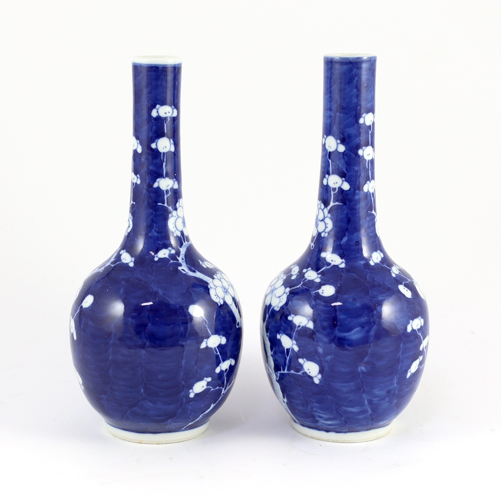 A pair of Chinese blue and white prunus bottle vases, early 20th century, 26cm